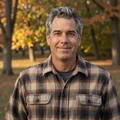 Portrait of Frank, 55, in a flannel shirt enjoying autumn in a Madison park
